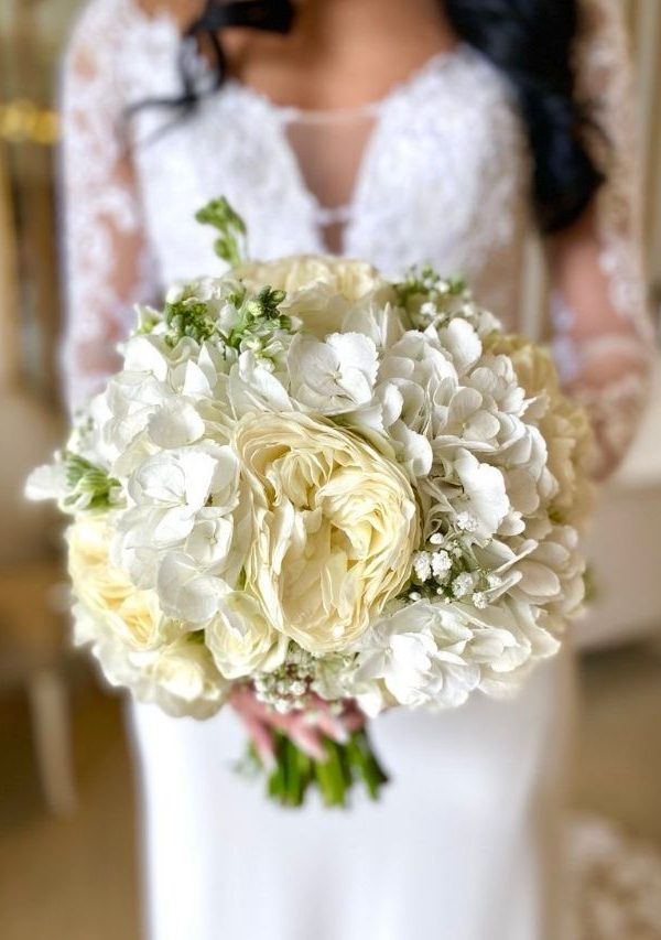 Bride holding a white rose bouquet - D&D