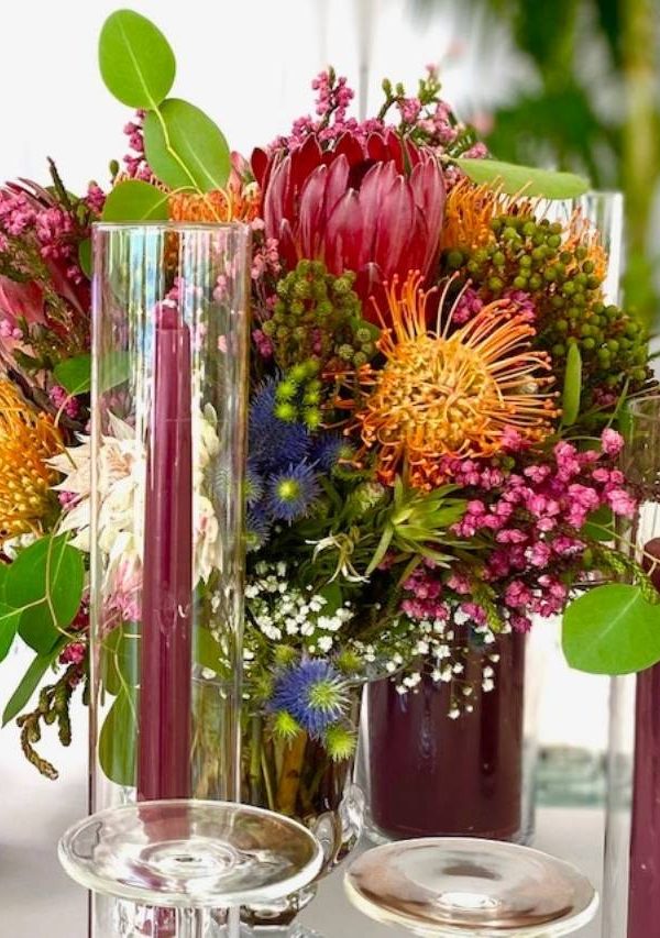 Maroon themed flowers at a reception - D&D